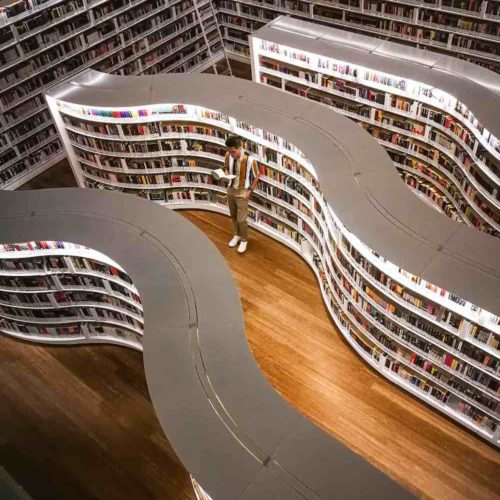 cof man reading book in french library
